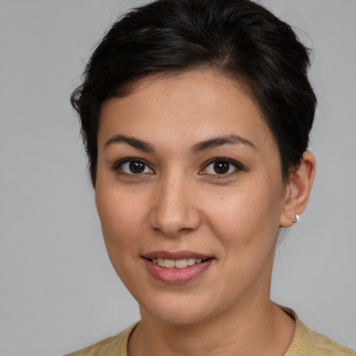 Joyful white young-adult female with short  brown hair and brown eyes