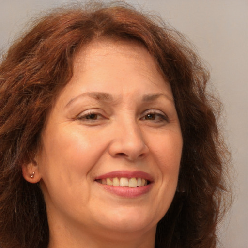 Joyful white adult female with long  brown hair and brown eyes