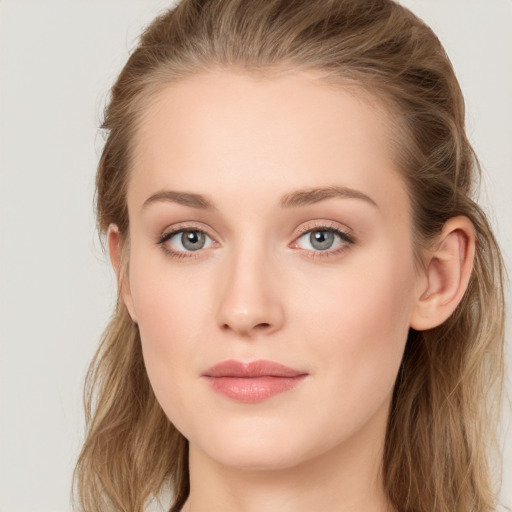 Joyful white young-adult female with long  brown hair and blue eyes