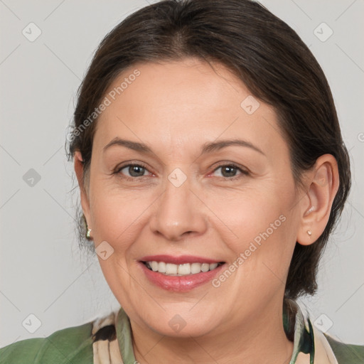 Joyful white adult female with medium  brown hair and brown eyes