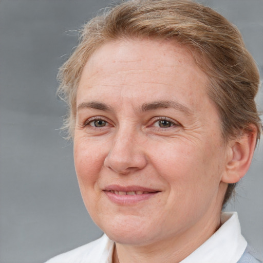 Joyful white adult female with short  brown hair and brown eyes