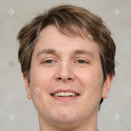 Joyful white adult male with short  brown hair and grey eyes