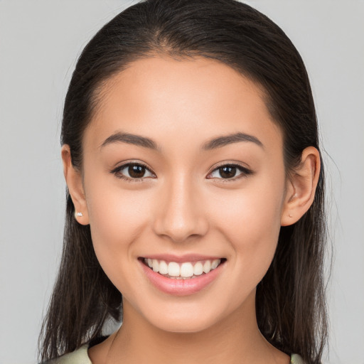 Joyful white young-adult female with long  brown hair and brown eyes