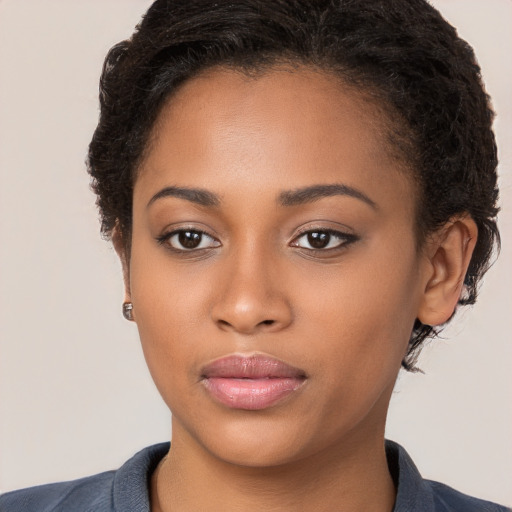 Joyful black young-adult female with medium  brown hair and brown eyes