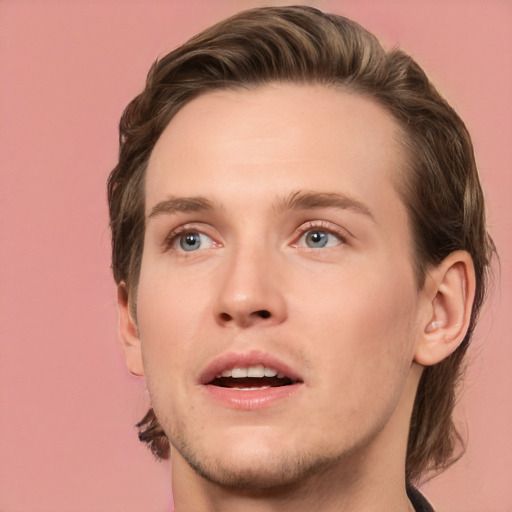 Joyful white young-adult male with medium  brown hair and green eyes