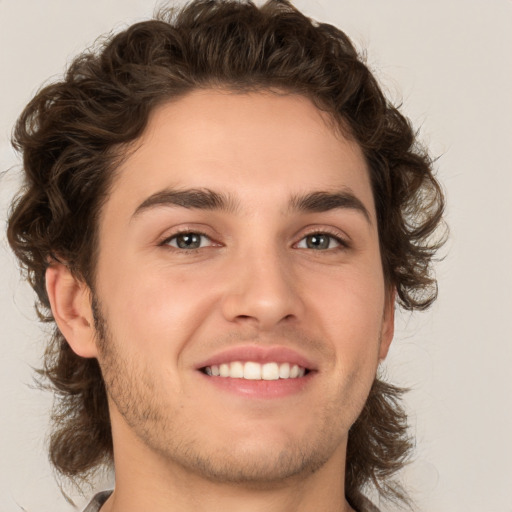 Joyful white young-adult male with medium  brown hair and brown eyes