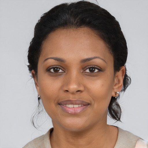 Joyful black young-adult female with medium  black hair and brown eyes