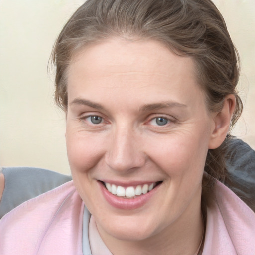 Joyful white young-adult female with medium  brown hair and blue eyes