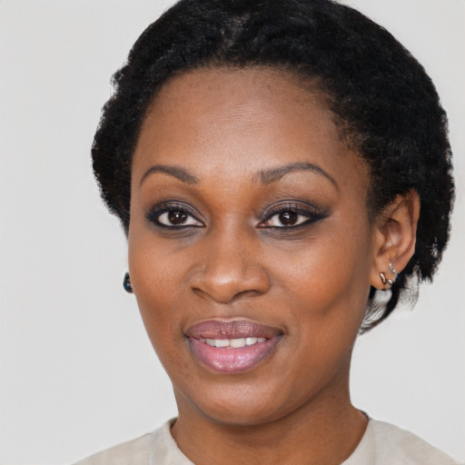 Joyful black young-adult female with short  black hair and brown eyes