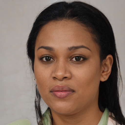 Joyful black young-adult female with medium  brown hair and brown eyes