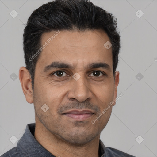 Joyful white adult male with short  black hair and brown eyes