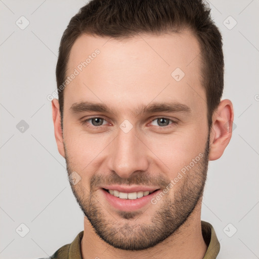 Joyful white young-adult male with short  brown hair and brown eyes