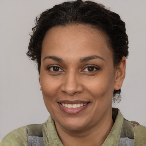 Joyful latino adult female with short  brown hair and brown eyes