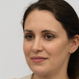 Joyful white adult female with long  brown hair and grey eyes