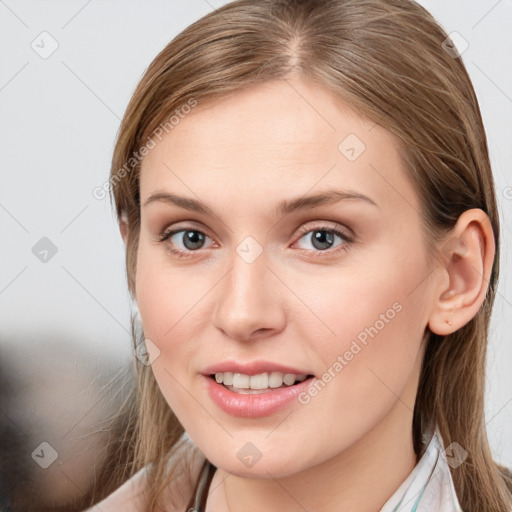 Joyful white young-adult female with long  brown hair and grey eyes