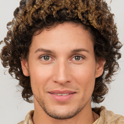 Joyful white young-adult male with medium  brown hair and brown eyes