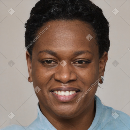 Joyful black young-adult female with short  black hair and brown eyes