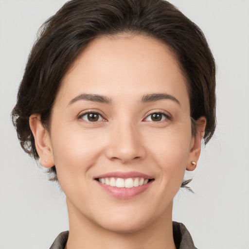 Joyful white young-adult female with medium  brown hair and brown eyes