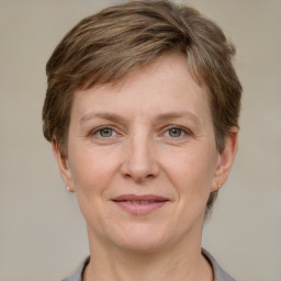 Joyful white adult female with short  brown hair and grey eyes