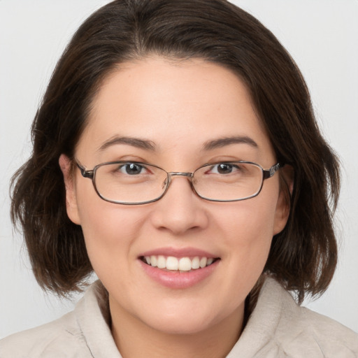 Joyful white young-adult female with medium  brown hair and brown eyes