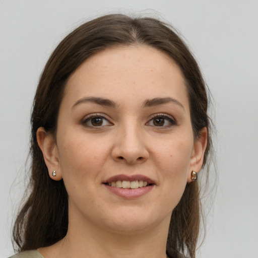 Joyful white young-adult female with medium  brown hair and grey eyes