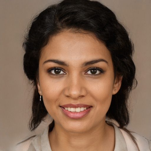 Joyful latino young-adult female with medium  brown hair and brown eyes