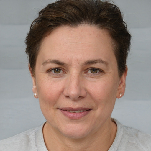 Joyful white adult female with short  brown hair and brown eyes