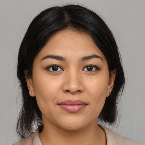Joyful asian young-adult female with medium  brown hair and brown eyes
