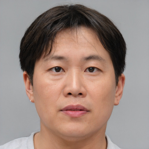 Neutral asian adult male with short  brown hair and brown eyes