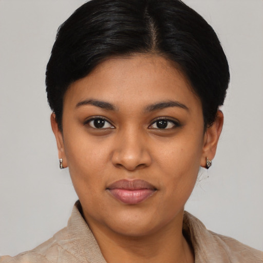 Joyful latino young-adult female with short  black hair and brown eyes