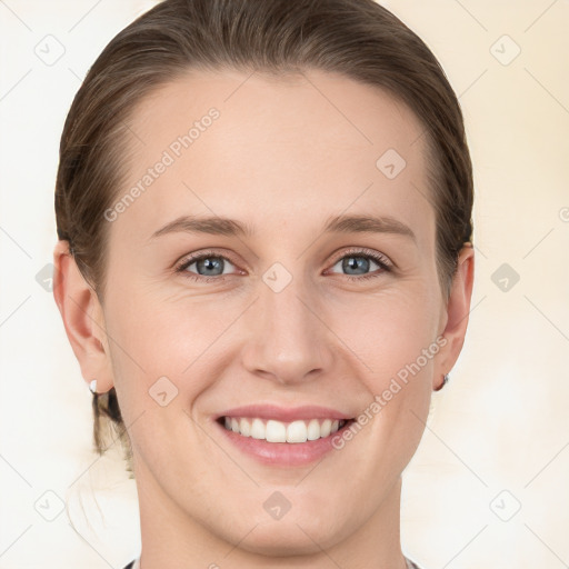 Joyful white young-adult female with short  brown hair and grey eyes