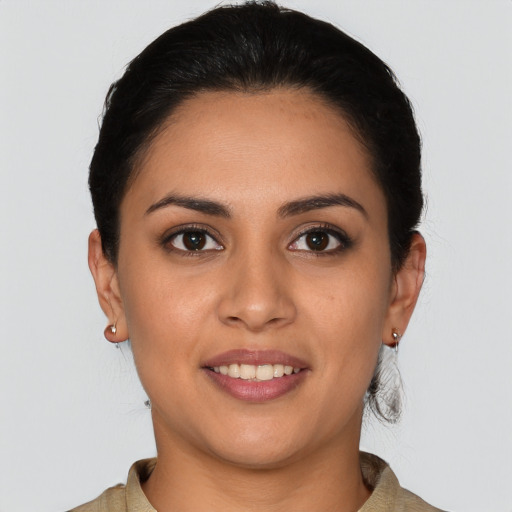 Joyful latino young-adult female with short  brown hair and brown eyes