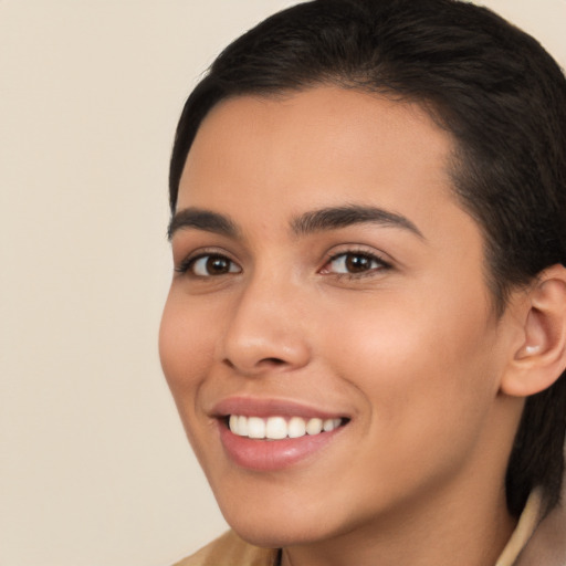 Joyful latino young-adult female with short  brown hair and brown eyes