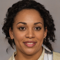 Joyful black adult female with medium  brown hair and brown eyes