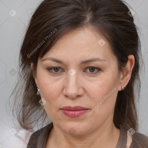 Joyful white adult female with medium  brown hair and grey eyes