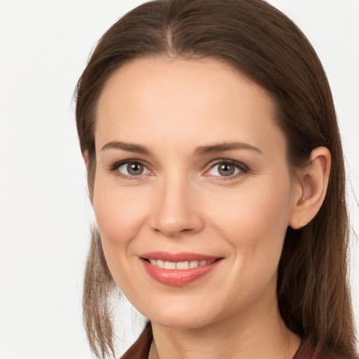 Joyful white young-adult female with long  brown hair and grey eyes