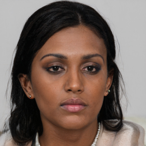 Neutral black young-adult female with medium  brown hair and brown eyes