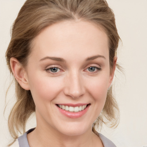 Joyful white young-adult female with medium  brown hair and blue eyes