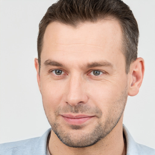 Joyful white adult male with short  brown hair and brown eyes