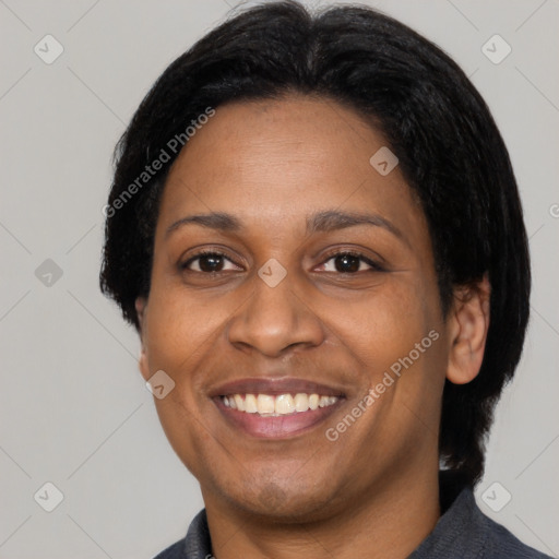 Joyful latino adult female with medium  black hair and brown eyes