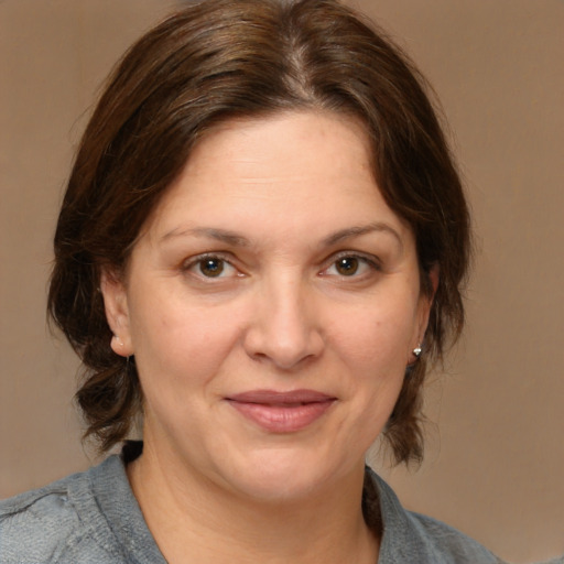 Joyful white adult female with medium  brown hair and brown eyes