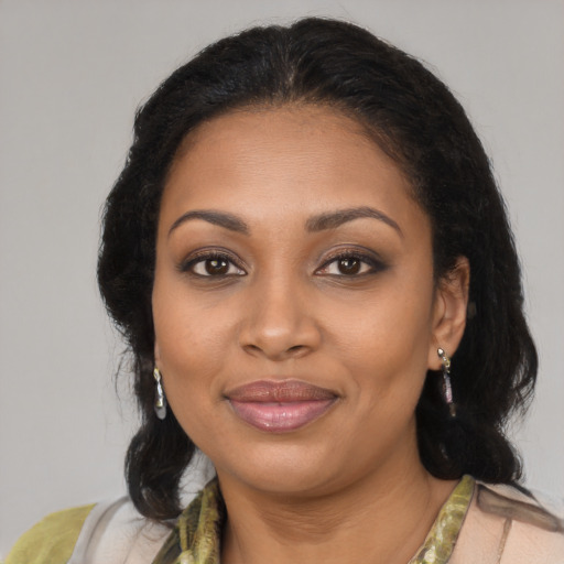 Joyful black young-adult female with medium  brown hair and brown eyes