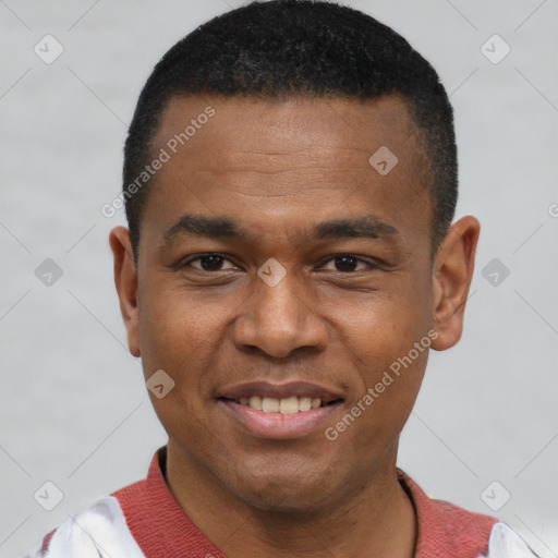 Joyful black young-adult male with short  black hair and brown eyes