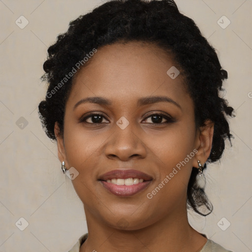 Joyful black young-adult female with short  black hair and brown eyes