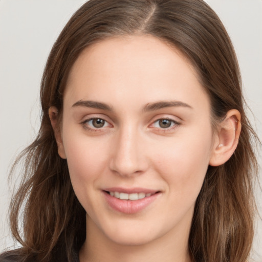 Joyful white young-adult female with long  brown hair and grey eyes