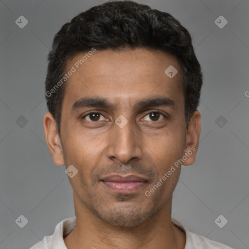 Joyful latino young-adult male with short  brown hair and brown eyes