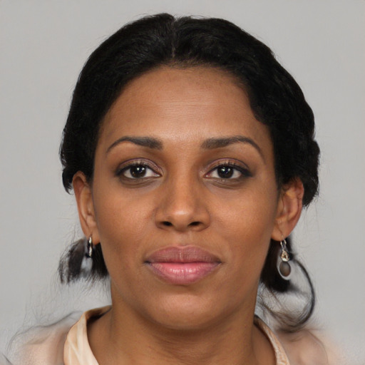 Joyful black young-adult female with medium  brown hair and brown eyes