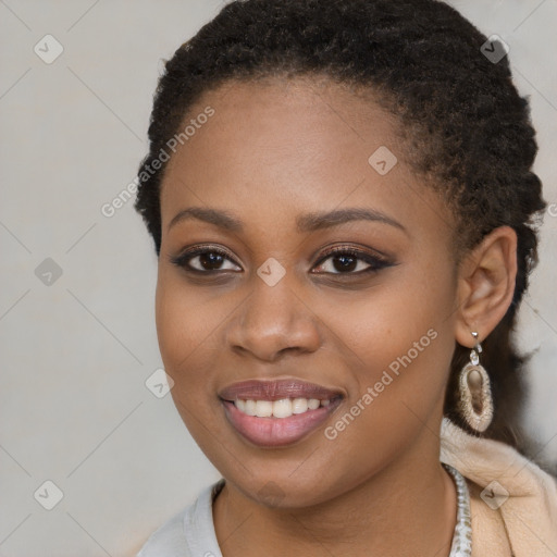 Joyful black young-adult female with long  brown hair and brown eyes