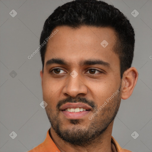 Joyful black young-adult male with short  black hair and brown eyes