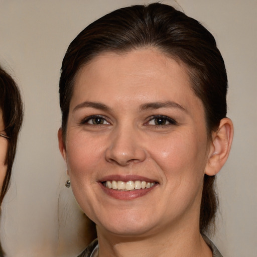 Joyful white young-adult female with medium  brown hair and brown eyes